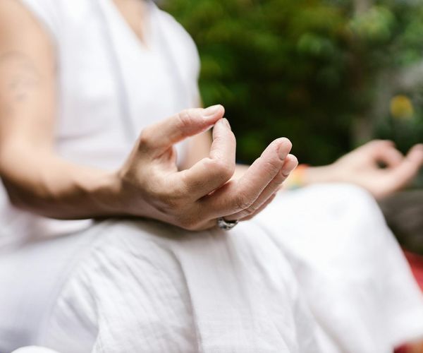 Close up of hands in mudra position during meditation practice