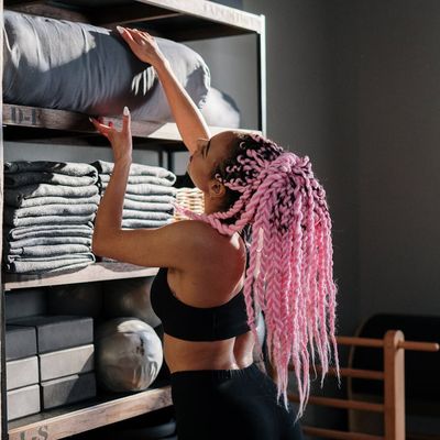 Professional yoga instructor Sofia Hernandez smiling in studio